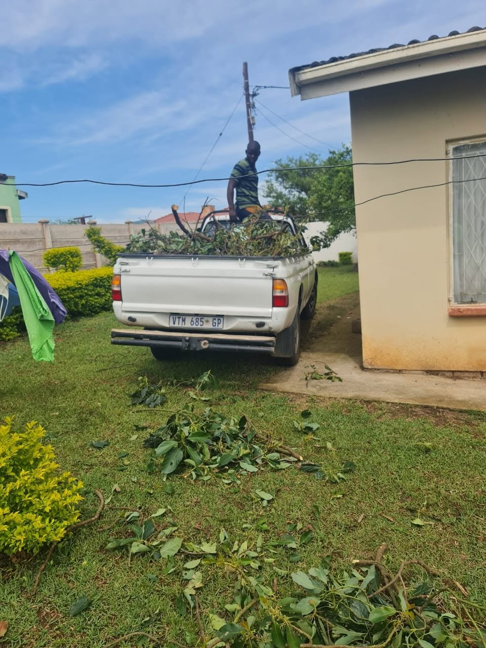 MMT team loading branches onto truck after yard clearing